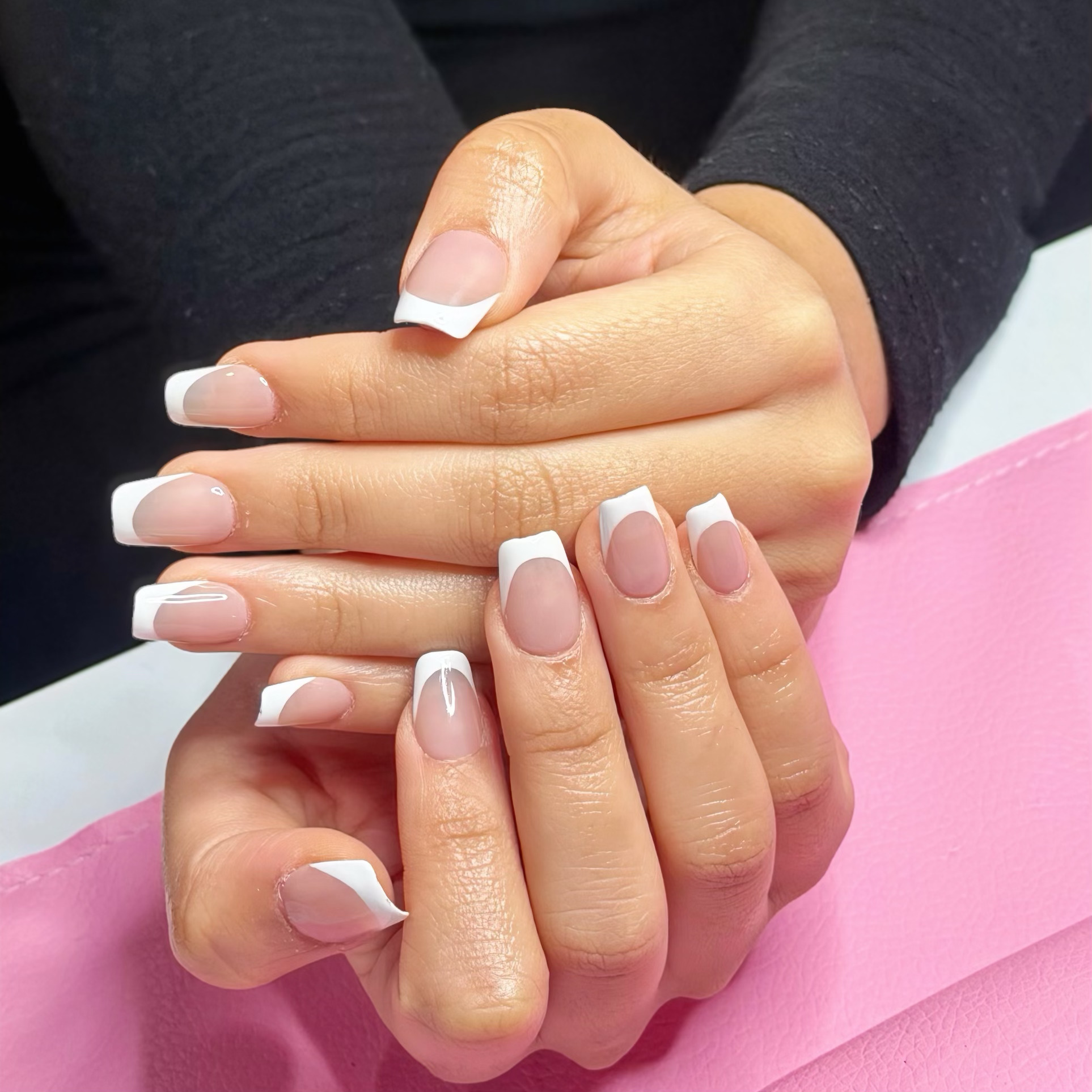 Professional onsite application of press-on nails.